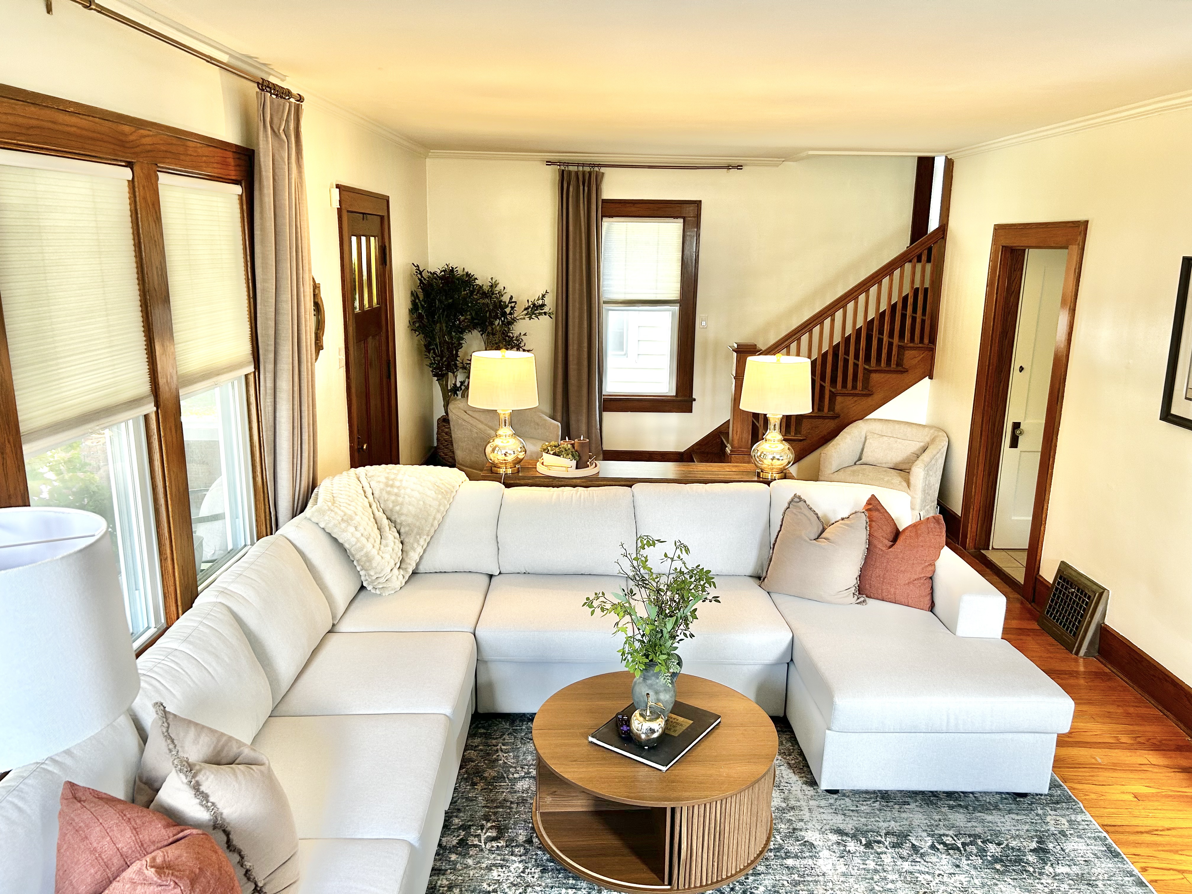 The Mac House — living room with fireplace and craftsman staircase